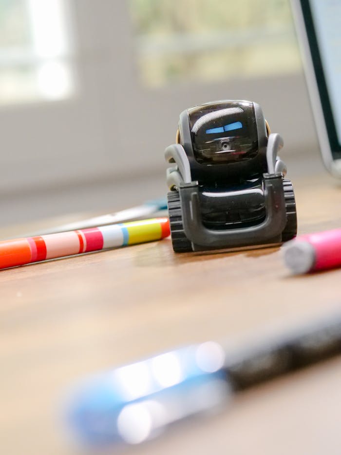 why-choose-us Futuristic small robot on a desk, symbolizing modern technology and innovation.